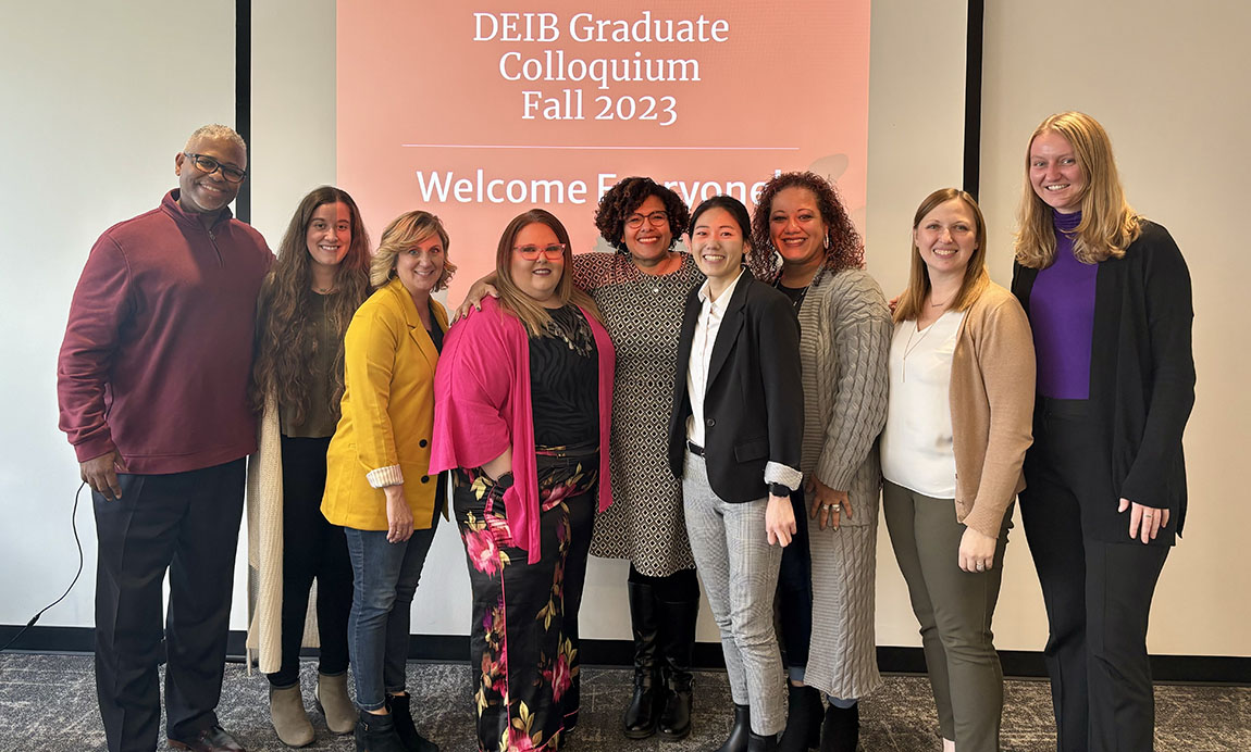 Students in the diversity, equity, inclusion and belonging graduate certificate program pose for a photo in front of a slide that says DEIB Graduate Colloquium Fall 2023